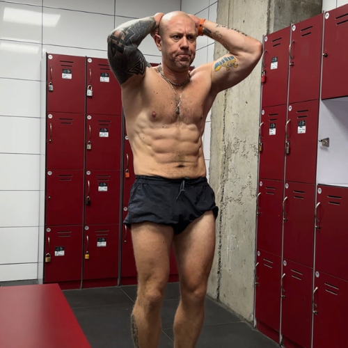 Man in gym locker room preparing for workout